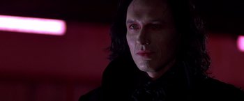 Movie still from “Vampires” (1998), directed by John Carpenter – A person with long black hair; Close Up shot, Low angle