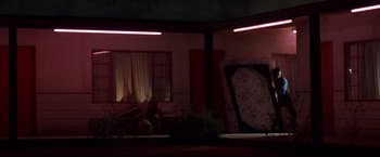 Movie still from “Vampires” (1998), directed by John Carpenter – A room that has a couch in it; Extreme Wide shot, Low angle