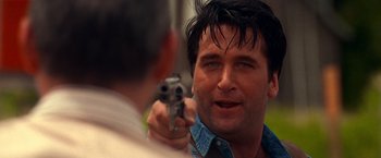 Movie still from “Vampires” (1998), directed by John Carpenter – A person holding a gun pointed at another person; Close Up shot, Over the shoulder angle