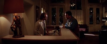 Movie still from “Vampires” (1998), directed by John Carpenter – Two men are sitting at a table in a restaurant; Wide shot, Over the shoulder angle