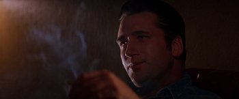 Movie still from “Vampires” (1998), directed by John Carpenter – A person smoking a cigarette; Close Up shot, Low angle