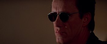 Movie still from “Vampires” (1998), directed by John Carpenter – A person wearing sunglasses; Close Up shot, Low angle