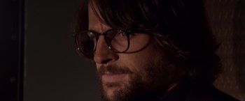 Movie still from “Vampires” (1998), directed by John Carpenter – A person wearing glasses; Close Up shot, Over the shoulder angle