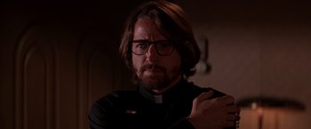 Movie still from “Vampires” (1998), directed by John Carpenter – A man wearing glasses and a priest's outfit; Close Up shot, Low angle