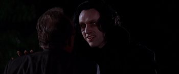 Movie still from “Vampires” (1998), directed by John Carpenter – A person wearing a black shirt; Close Up shot, Over the shoulder angle