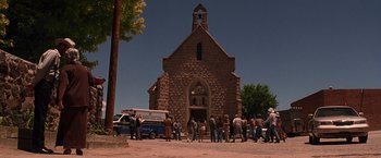Movie still from “Vampires” (1998), directed by John Carpenter – A group of people standing in front of a church; Extreme Wide shot, Low angle