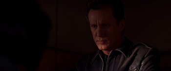 Movie still from “Vampires” (1998), directed by John Carpenter – A person wearing headphones; Close Up shot, Over the shoulder angle