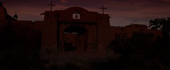 Movie still from “Vampires” (1998), directed by John Carpenter – A building with a bell on top of it and two crosses on top of it; Extreme Wide shot, Low angle