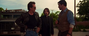 Movie still from “Vampires” (1998), directed by John Carpenter – A group of men standing next to each other on a street; Medium shot, Low angle