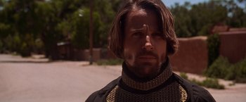 Movie still from “Vampires” (1998), directed by John Carpenter – A person with long hair and a beard; Close Up shot, Low angle