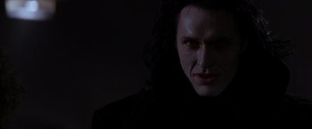 Movie still from “Vampires” (1998), directed by John Carpenter – A person with long black hair; Close Up shot, Low angle