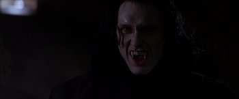 Movie still from “Vampires” (1998), directed by John Carpenter – A person with long hair wearing a vampire costume; Close Up shot, Low angle