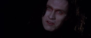 Movie still from “Vampires” (1998), directed by John Carpenter – A man's face in the dark; Close Up shot, Low angle