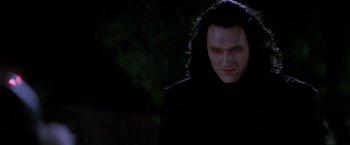 Movie still from “Vampires” (1998), directed by John Carpenter – A person wearing a black jacket; Close Up shot, Low angle