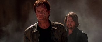 Movie still from “Vampires” (1998), directed by John Carpenter – A man with a bloody face standing next to another man with a beard; Close Up shot, Low angle