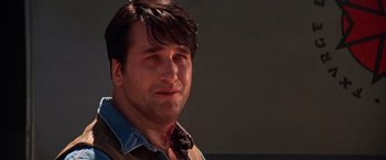 Movie still from “Vampires” (1998), directed by John Carpenter – A person wearing a shirt and tie; Close Up shot, Low angle