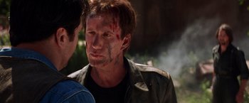 Movie still from “Vampires” (1998), directed by John Carpenter – A man in a leather jacket with blood all over his face; Close Up shot, Over the shoulder angle