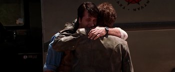 Movie still from “Vampires” (1998), directed by John Carpenter – A couple of men hugging each other in a room; Close Up shot, Over the shoulder angle