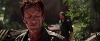 Movie still from “Vampires” (1998), directed by John Carpenter – A man with blood all over his face and head; Close Up shot, Over the shoulder angle