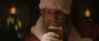 Movie still from “Violent Night” (2022), directed by Tommy Wirkola – A man dressed as santa claus holding a glass of beer; Close Up shot, Low angle