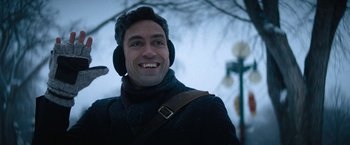 Movie still from “Violent Night” (2022), directed by Tommy Wirkola – A man wearing ear warmers and a jacket; Close Up shot, Over the shoulder angle
