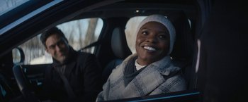 Movie still from “Violent Night” (2022), directed by Tommy Wirkola – A woman sitting in the back seat of a car; Close Up shot, Over the shoulder angle