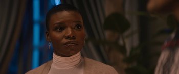 Movie still from “Violent Night” (2022), directed by Tommy Wirkola – A person with short hair; Close Up shot, Over the shoulder angle