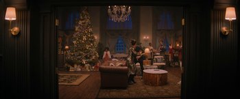 Movie still from “Violent Night” (2022), directed by Tommy Wirkola – A living room filled with furniture next to a christmas tree; Extreme Wide shot, High angle