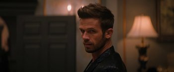 Movie still from “Violent Night” (2022), directed by Tommy Wirkola – A person wearing a leather jacket; Close Up shot, Over the shoulder angle