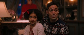 Movie still from “Violent Night” (2022), directed by Tommy Wirkola – A man and a little girl sitting next to each other; Close Up shot, Over the shoulder angle