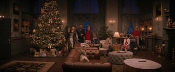 Movie still from “Violent Night” (2022), directed by Tommy Wirkola – A group of people standing around a living room; Extreme Wide shot, High angle