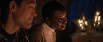 Movie still from “Violent Night” (2022), directed by Tommy Wirkola – A woman in a white shirt and a man in a brown jacket; Close Up shot, Over the shoulder angle