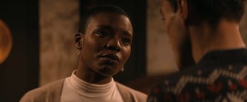 Movie still from “Violent Night” (2022), directed by Tommy Wirkola – A black woman with short black hair is talking to another woman; Close Up shot, Over the shoulder angle