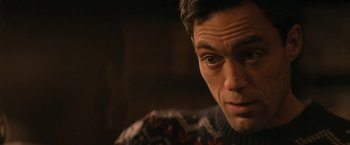 Movie still from “Violent Night” (2022), directed by Tommy Wirkola – A person wearing a sweater; Close Up shot, Over the shoulder angle