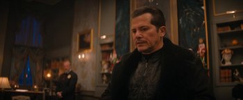 Movie still from “Violent Night” (2022), directed by Tommy Wirkola – A person wearing a jacket; Medium shot, Over the shoulder angle