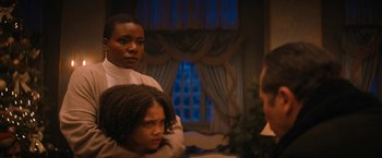 Movie still from “Violent Night” (2022), directed by Tommy Wirkola – Two women are looking at each other in the mirror; Medium shot, Over the shoulder angle