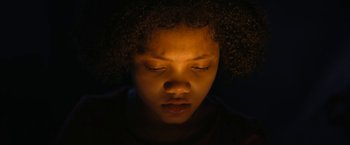 Movie still from “Violent Night” (2022), directed by Tommy Wirkola – A person with their eyes closed; Close Up shot, Low angle