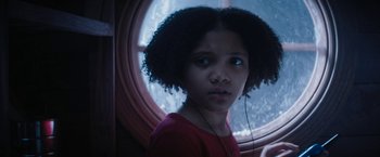 Movie still from “Violent Night” (2022), directed by Tommy Wirkola – A young girl is looking out of a window; Close Up shot, Low angle