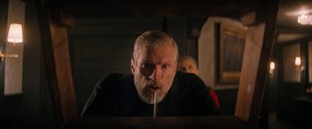 Movie still from “Violent Night” (2022), directed by Tommy Wirkola – A man with a beard is looking at the camera; Medium shot, Low angle