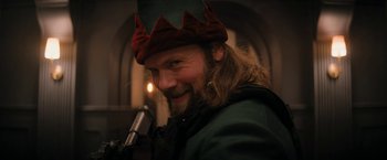 Movie still from “Violent Night” (2022), directed by Tommy Wirkola – A person wearing a hat; Close Up shot, Low angle