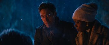 Movie still from “Violent Night” (2022), directed by Tommy Wirkola – A man and a woman standing next to each other in the snow; Close Up shot, Over the shoulder angle
