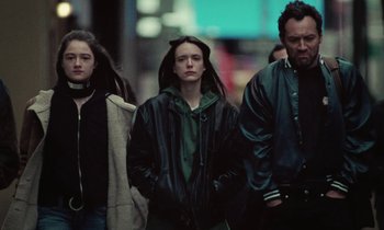 Movie still from “Vox Lux” (2018), directed by Brady Corbet – A group of people walking down a street; Medium shot, Low angle