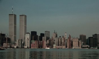 Movie still from “Vox Lux” (2018), directed by Brady Corbet – A view of a large city from across the water; Extreme Wide shot, Low angle
