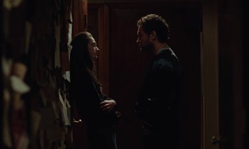 Movie still from “Vox Lux” (2018), directed by Brady Corbet – A man and a woman standing next to each other; Medium shot, High angle