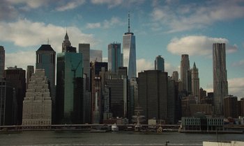 Movie still from “Vox Lux” (2018), directed by Brady Corbet – A view of a city skyline from across the water; Extreme Wide shot, High angle