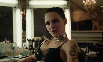 Movie still from “Vox Lux” (2018), directed by Brady Corbet – A woman in a black bra with a snake tattoo on her arm; Close Up shot, Over the shoulder angle
