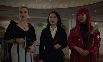 Movie still from “Vox Lux” (2018), directed by Brady Corbet – A group of women standing next to each other in a room; Medium shot, Low angle