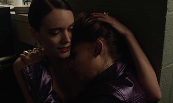 Movie still from “Vox Lux” (2018), directed by Brady Corbet – Two women are embracing each other in the dark; Close Up shot, Overhead angle
