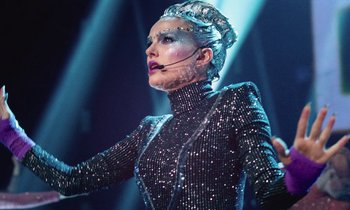Movie still from “Vox Lux” (2018), directed by Brady Corbet – A woman in a black and silver costume; Medium shot, Low angle