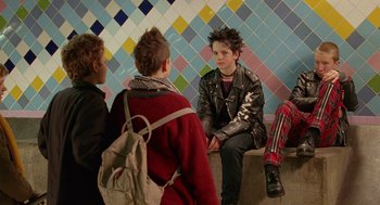 A group of young people sitting on a bench